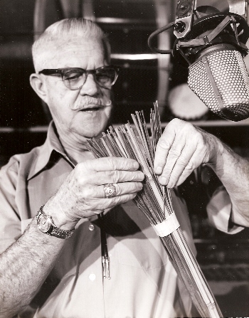 Jimmy MacDonald holding the roll of bamboo that was used to create one of the sound layers for the devastating forest fire in Bambi. Article written by Adriane Kuzminski.