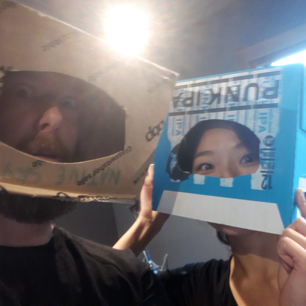 Jeff and Mimi have some fun in the Foley studio by sliding cut-out boxes over their heads.